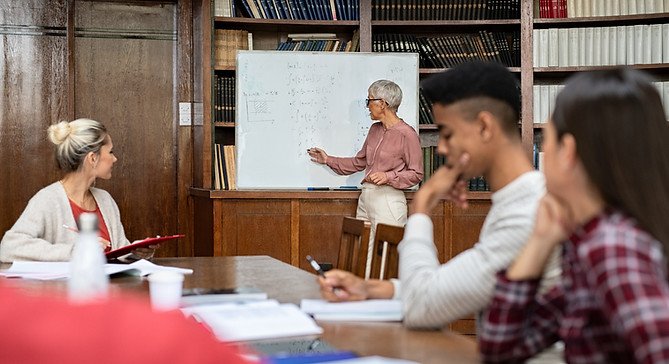 Teacher working with high school students on college planning